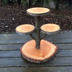 three tiered tree stump stand on wooden deck