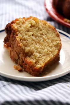 two slices of banana bread on a plate next to a loaf of bread in the background