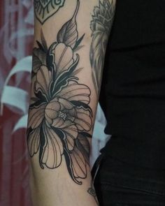 a woman with a flower tattoo on her arm