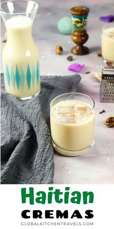 two glasses filled with cream sitting on top of a table