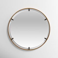 a round mirror hanging on the wall