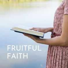 a woman in a pink dress holding a book with the words fruitful faith on it