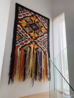 the wall hanging is decorated with multicolored fringes