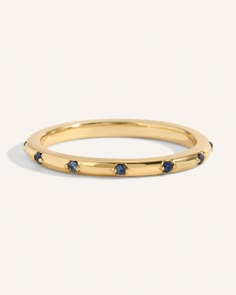 a yellow gold ring with blue sapphire stones