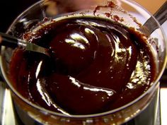 a glass bowl filled with chocolate pudding on top of a table