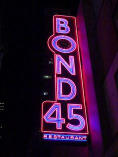 the neon sign for bond 45 restaurant is lit up