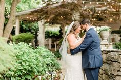 a bride and groom standing in front of a gazebo