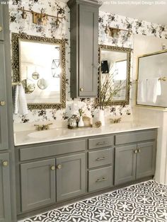 a bathroom with two sinks and mirrors on the wall next to each other in gray cabinets