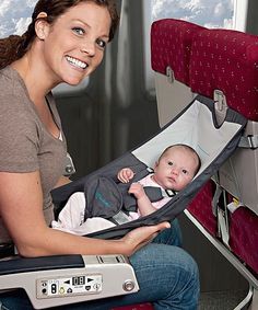 a woman holding a baby in a stroller