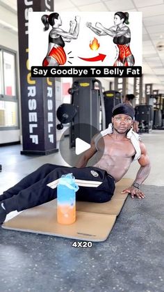 a man laying on top of a mat in a gym