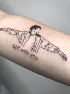 a person with a tattoo on their arm that says, still with you