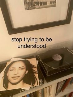 a record player sitting on top of a book shelf