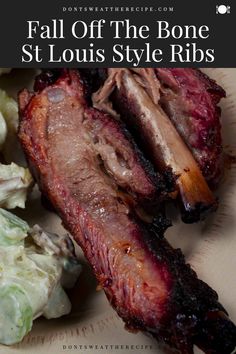 a plate with meat, cabbage and lettuce on it that says fall off the bone st louis style ribs