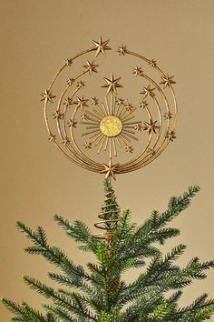 a small christmas tree with gold stars on it