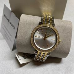 Nwt Michael Kors Darci Two-Tone Stainless Steel Watch 39mm Mk3215 Retail $250 An Elegant Addition To Your Collection: A Glistening Darci Watch From Michael Kors. Stainless Steel Bracelet With Gold-Tone Accents And Deployant Clasp (6-9/10" L) Round Case, 39mm, Gold-Tone Bezel With Crystal Accents Silver-Tone Dial With Gold-Tone Stick Indices, Three Hands And Logo Quartz Movement Water Resistant To 50 Meters Mk Watch Women Gold, Michael Kors Watches Women, Michael Kors Watch Women's, Mk Watch Women, Classy Watches, Dope Jewelry Accessories, Mk Watch, Watches Women Michael Kors, Classy Watch