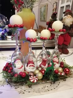 wine glasses filled with christmas decorations on a table