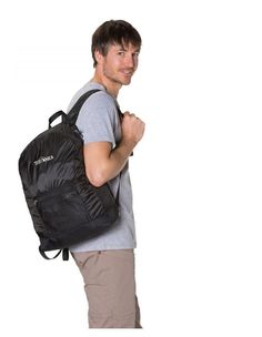 a man with a backpack on his back is smiling at the camera while standing against a white background