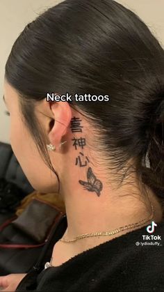 the back of a woman's neck with chinese writing on her left side ear