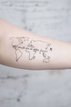 a woman's arm with a world map tattoo on the left side of her arm