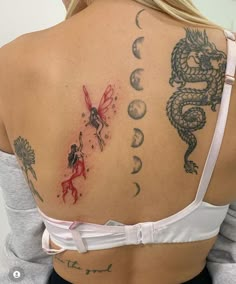 the back of a woman's shoulder with dragon and moon tattoos on her left side