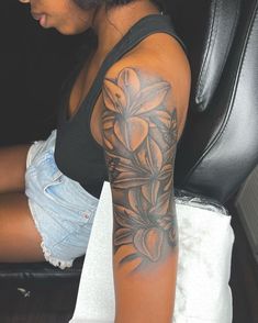 a woman with a flower tattoo on her arm