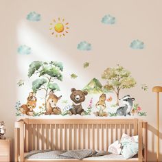 a baby's room with a crib and wall decals