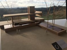 an architectural model of a house with trees in the foreground and mountains in the background