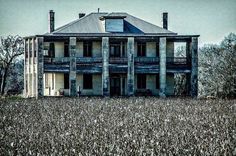 an old house in the middle of a field