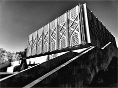 a black and white photo of a bridge with intricate designs on it's side