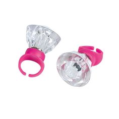 two pieces of plastic with pink handles and clear glass in the middle, on a white background