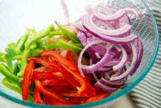 onions, peppers and green beans in a glass bowl