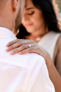 a man and woman holding each other close together