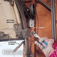 a person in white gloves working on a piece of wood with wires attached to it