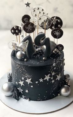 a black and white cake with silver decorations