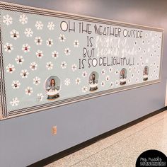 a bulletin board with pictures on it in an office building lobby, decorated with snowflakes and sayings