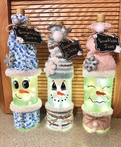 three lighted snowmen with hats and scarves