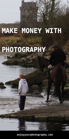 a man riding on the back of a brown horse next to a body of water