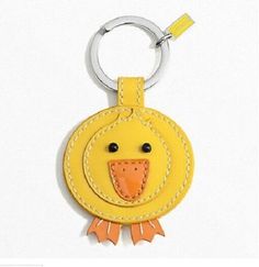 a yellow bird shaped keychain hanging from a metal ring