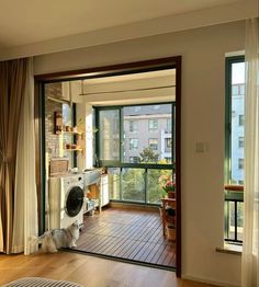 an open door leading to a living room with a washer and dryer in it