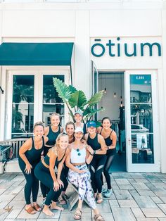 a group of women standing in front of a store