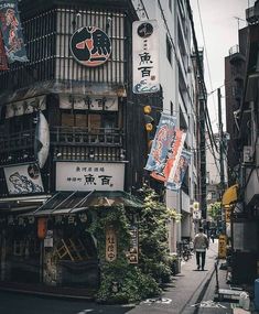 an alleyway with signs and buildings on both sides