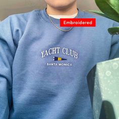 "*SIZES ARE UNISEX* -I'd suggest your usual size for a regular fit, or sizing up for a more relaxed fit. *these sweatshirts are extra comfy when oversized 🚩 \"Yacht Club Santa Monica\" embroidered on a cute vintage-style crewneck. A pre-shrunk, classic fit sweater that's made with air-jet spun yarn for a soft feel and reduced pilling. Your new favorite sweatshirt! * 50% cotton, 50% polyester * Pre-shrunk * Classic fit with no center crease * 1x1 athletic rib knit collar with spandex * Air-jet s Relaxed Fit Crew Sweatshirt With Letter Embroidery, Oversized Crew Sweatshirt With Embroidered Text, Sporty Crew Sweater With Letter Embroidery, Sporty Crew Neck Sweater With Letter Embroidery, Tote Embroidery, Chill Clothes, Club Sweatshirts, Tennis Fashion, Vintage Crewneck