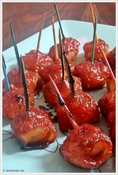 several skewered meats with toothpicks sticking out of them on a plate