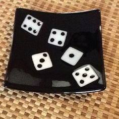 a black and white plate with dice on it