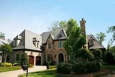 a large brick house with lots of windows and roofing on it's sides