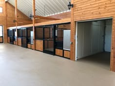 the inside of a horse barn with stalls and stalls on each side of the building