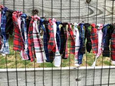 several scarves are hanging on a fence