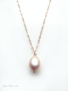 "Champagne Pink Freshwater Pearl Necklace ~ Available in 100% 14k gold fill, rose gold fill or sterling silver Capture the beauty of genuine pearls with this simple, elegant pearl drop necklace. ~ Genuine freshwater pearls have a gorgeous luster and the most beautiful champagne blush pink ~ Chain is a dainty and sparkly 14k gold fill, sterling silver or rose gold fill ~ Necklace closes with a spring clasp ~ Shown on model at 18\" length ~ Necklace is handcrafted, made to order, and packaged for Rose Gold 14k Gold Necklace With Pearl Pendant, Delicate Rose Gold Jewelry With Pearl Pendant, Delicate Rose Gold Briolette Jewelry, Rose Gold 14k Gold Briolette Necklace, Elegant Blush Necklace For Gift, Formal Rose Gold Briolette Necklace, Pear-shaped Rose Gold 14k Jewelry, 14k Rose Gold Pear-shaped Jewelry, 14k Rose Gold Briolette Necklace