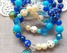 Kids mermaid bracelets kids party loot bag favor under the | Etsy Handmade Blue Charm Bracelet For Birthday, Blue Whimsical Bracelets For Gifts, Blue Whimsical Bracelets For Gift, Whimsical Blue Bracelets For Gifts, Loot Bags, Mermaid Bracelet, Sea Inspired, Mermaid Party, Ornament Wreath