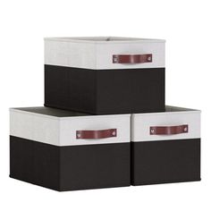 three black and white storage boxes with leather handles